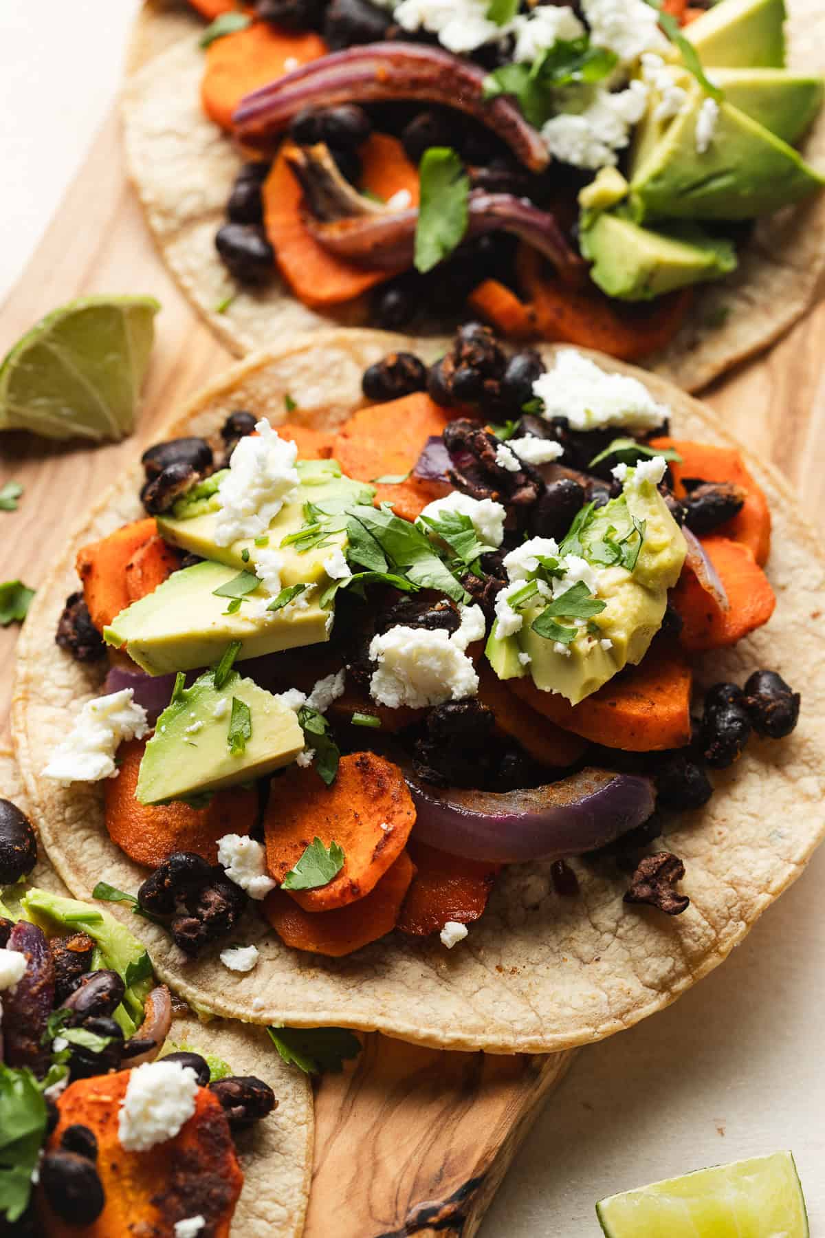 Vegetarian black bean tacos on serving board.