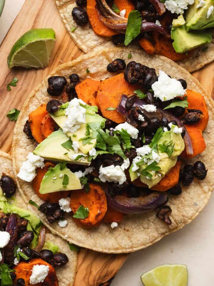 Vegetarian black bean tacos on serving board.
