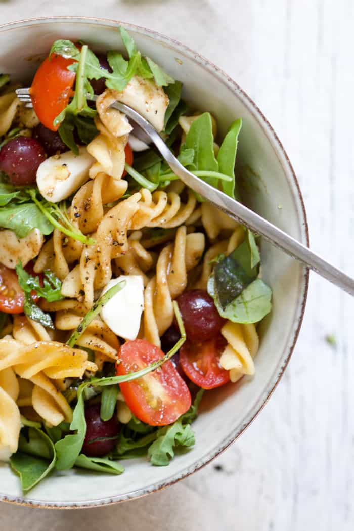 Fruity caprese pasta salad in a bowl