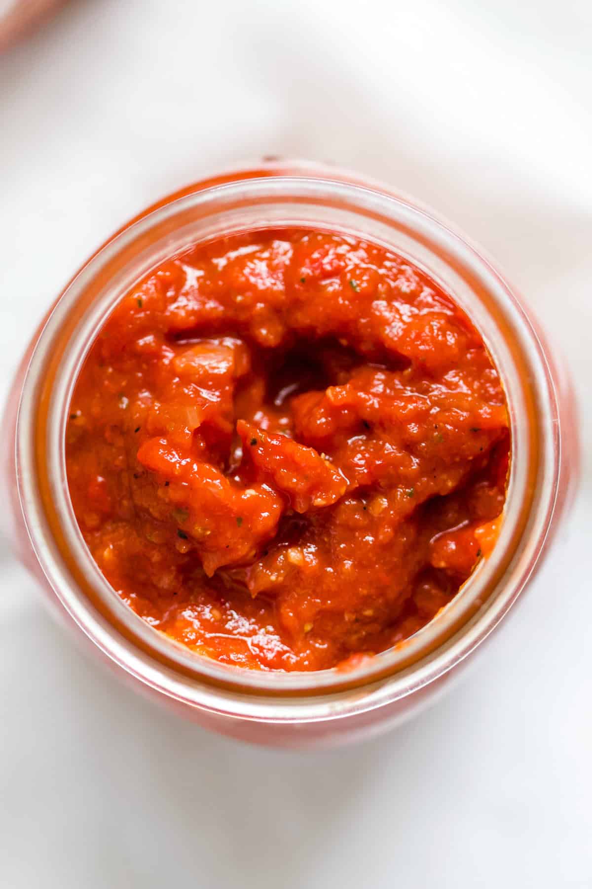 Roasted red pizza sauce in glass jar.