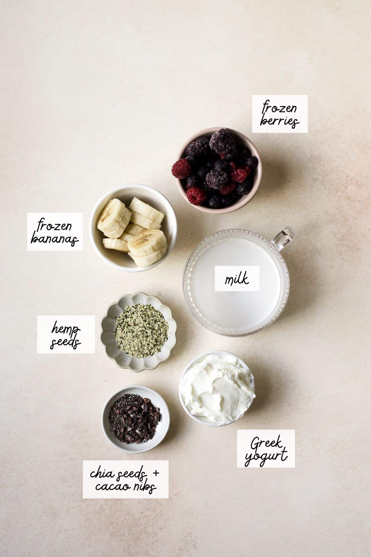 Ingredients needed to make a mixed berry protein smoothie.