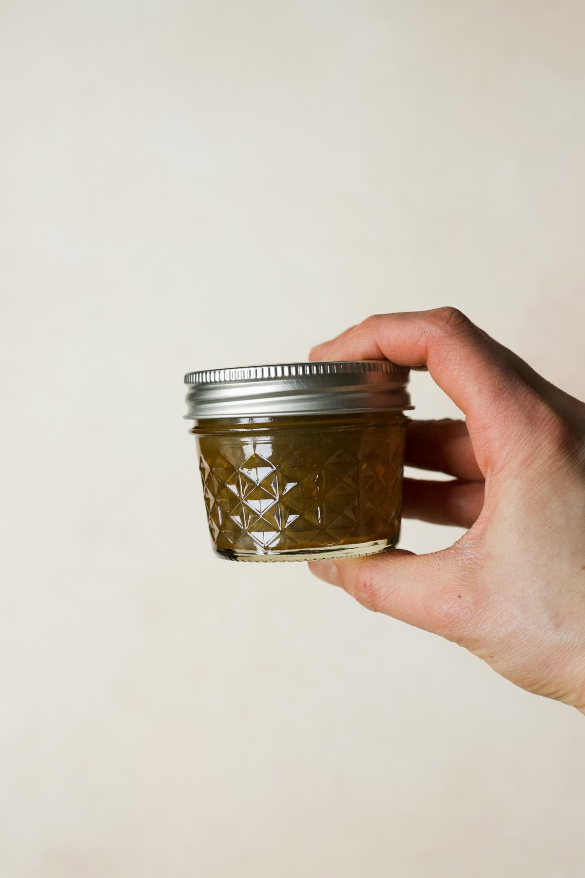 Balsamic vinaigrette shaken together in a small jar.