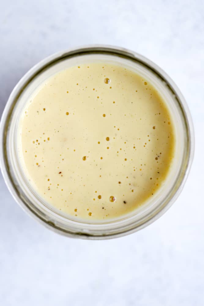 Creamy apple cider vinaigrette in small mason jar