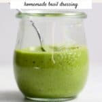 Basil dressing in a small jar.