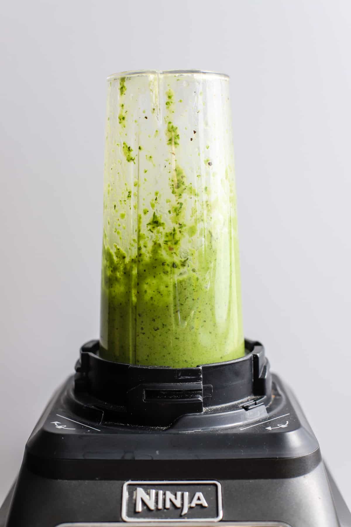 Homemade basil vinaigrette in a blender.