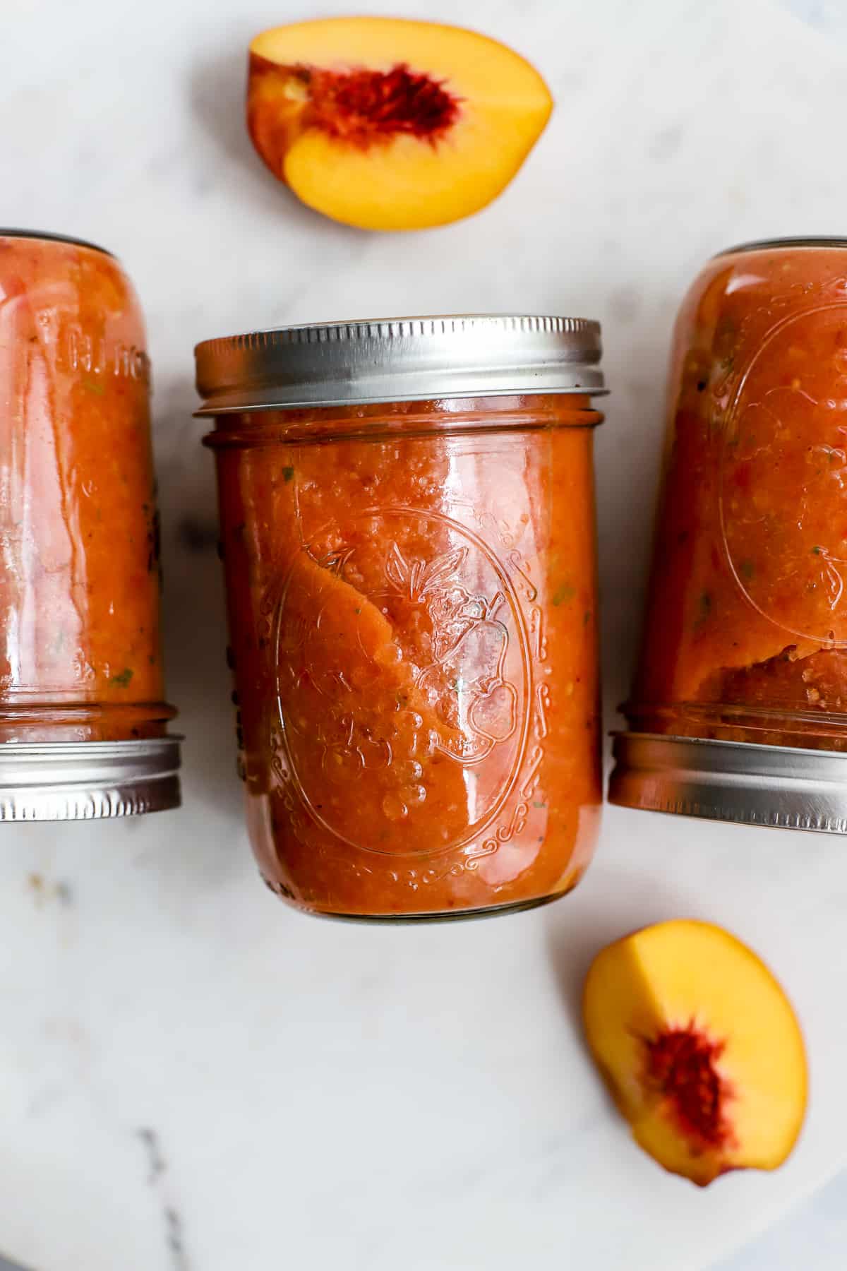 Peach gazpacho in widemouth mason jars for meal prep.