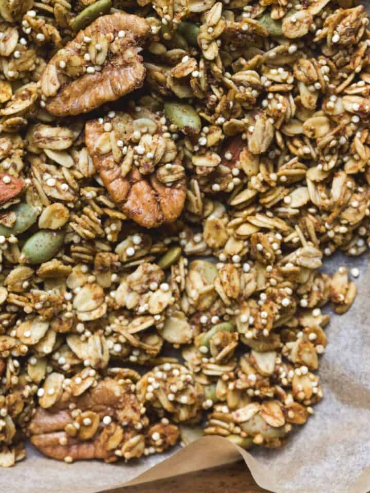 Pumpkin granola with quinoa, pepitas, and pecans, on a sheet pan.