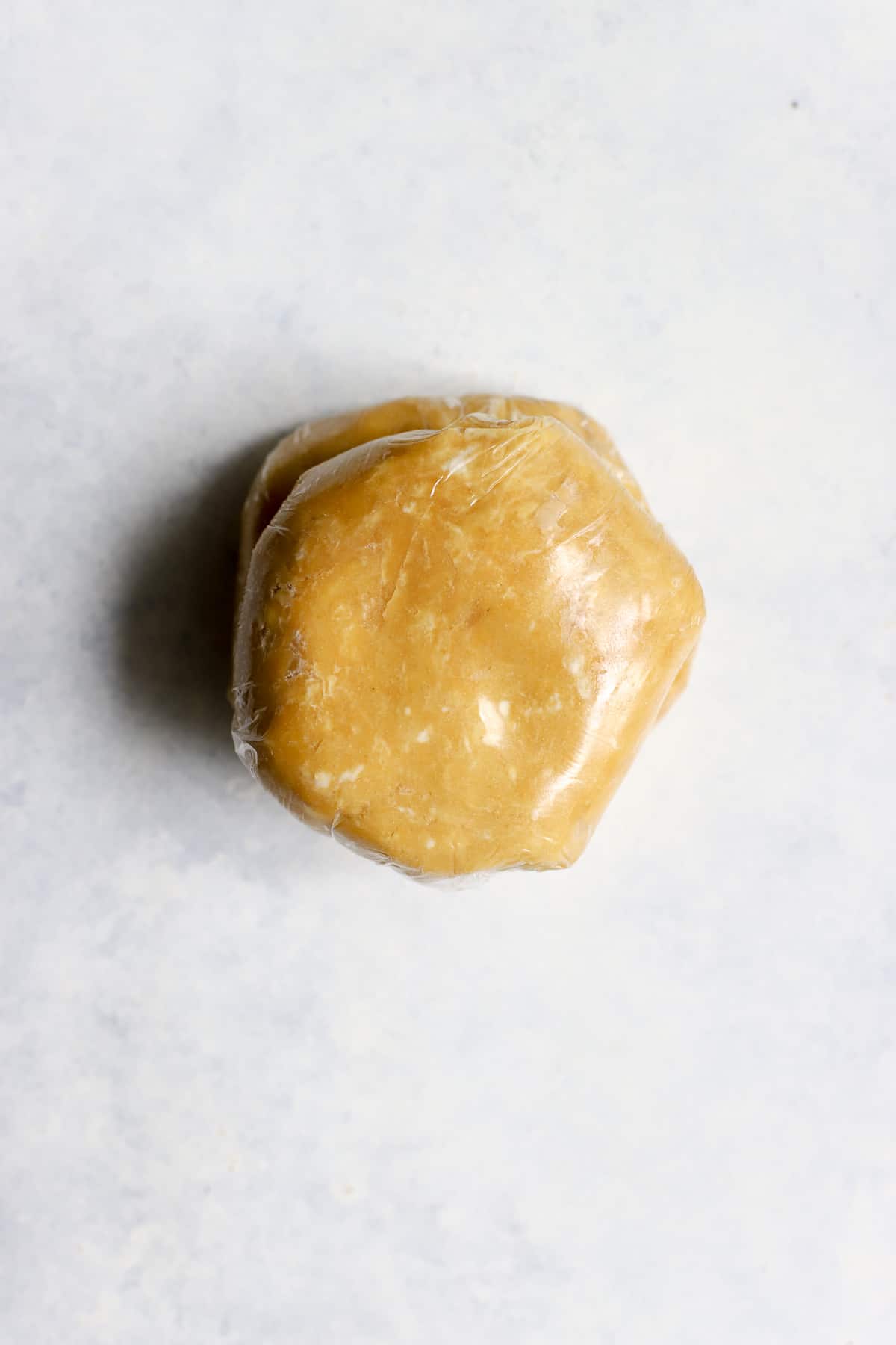 Discs of chickpea flour pie dough wrapped in plastic wrap