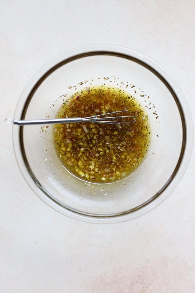 White bean marinade whisked together in a bowl.