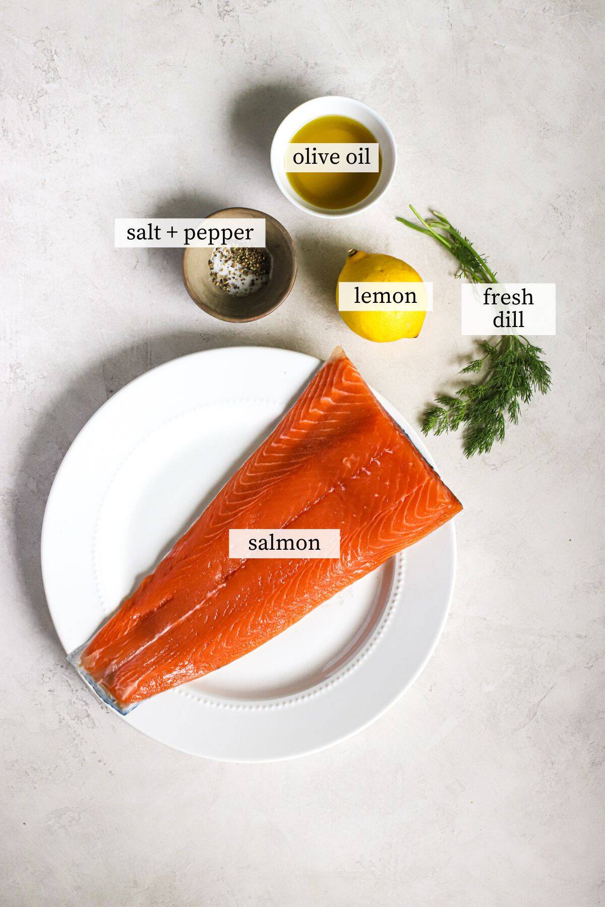 Ingredients needed to make simple baked lemon dill salmon.