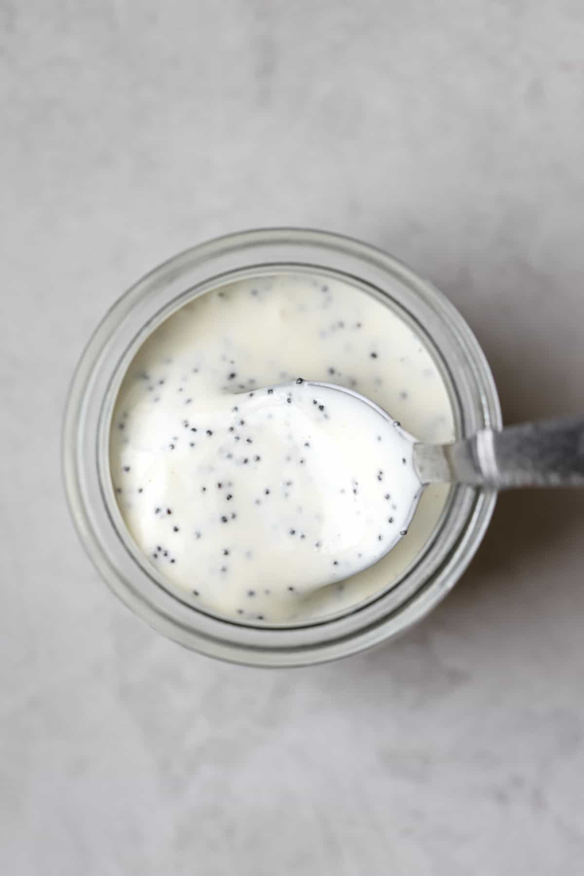 Creamy poppy seed dressing in a jar.