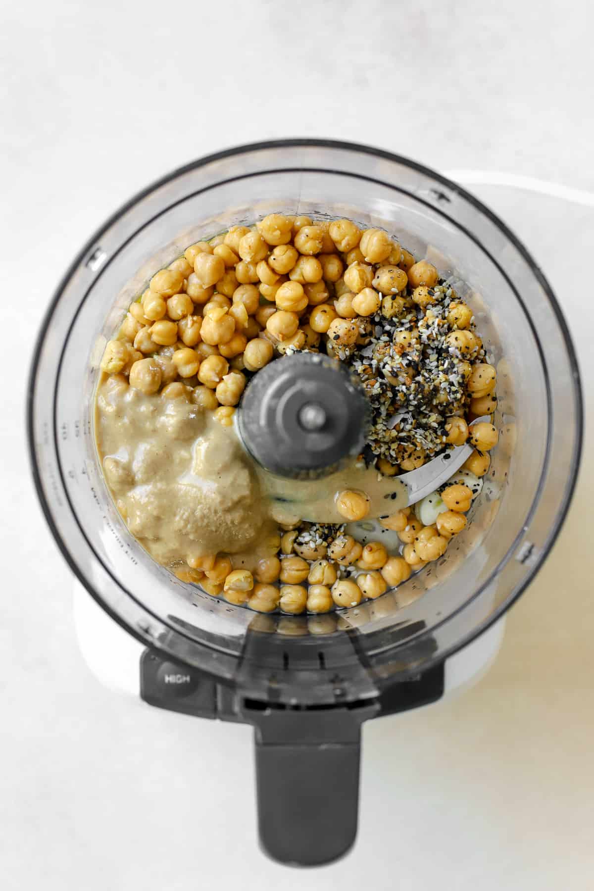 Hummus ingredients in food processor before being blended.