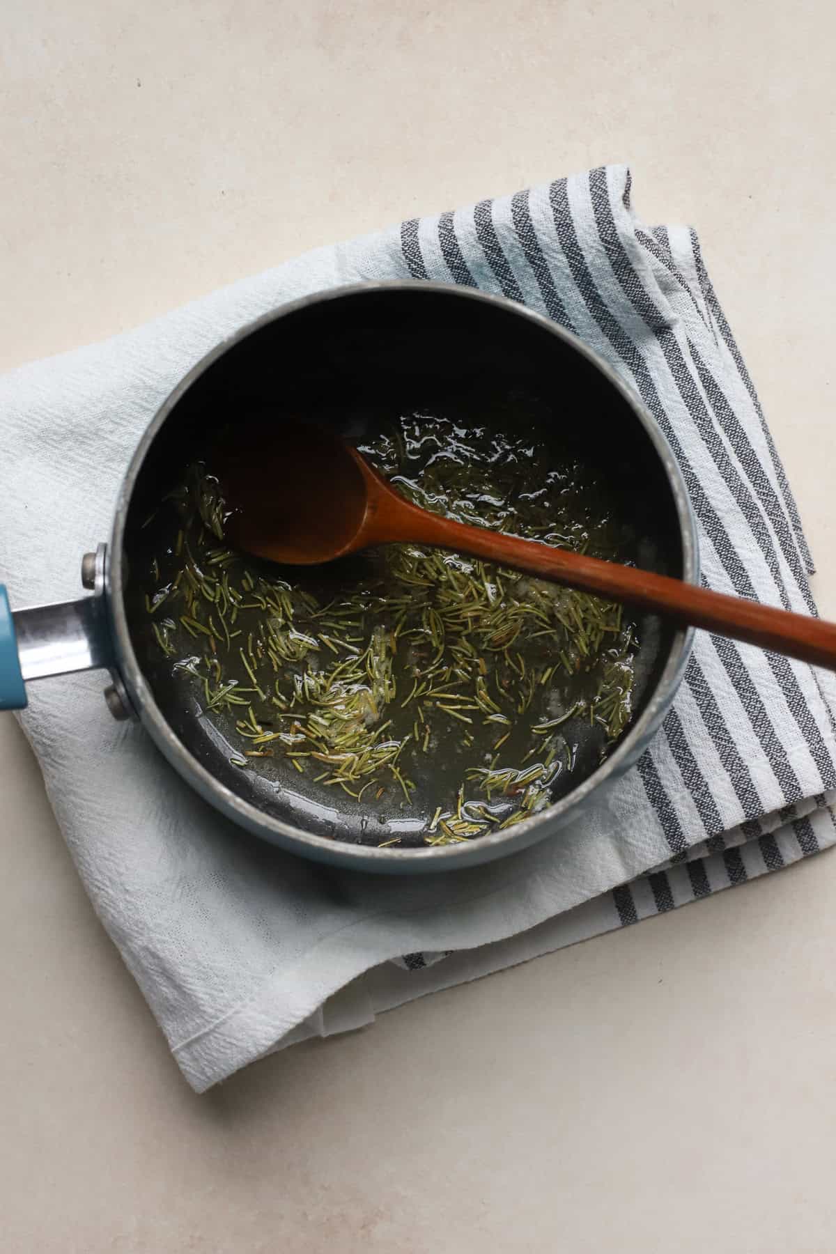 Rosemary and salt toasting in melted butter and honey in a small saucepan.