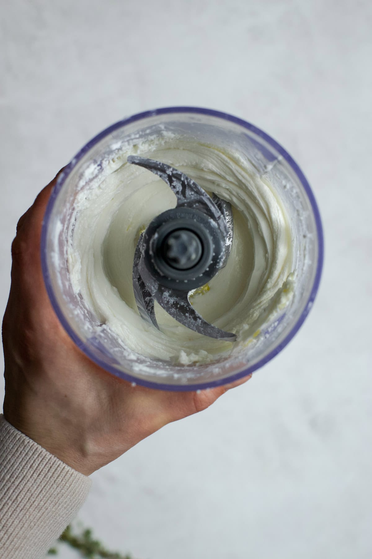 Whipped goat cheese in food processor.