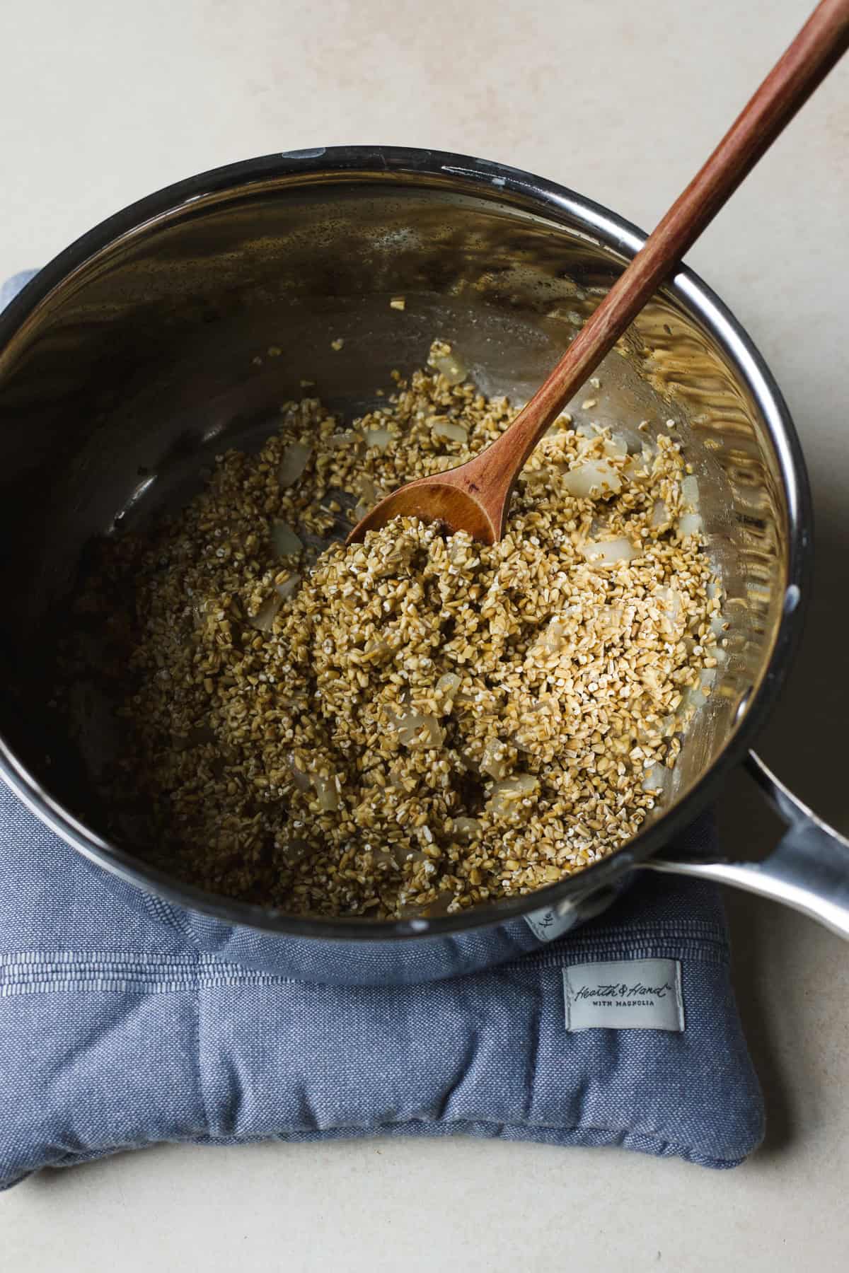 Toasting steel cut oats in a pot with onions and miso.