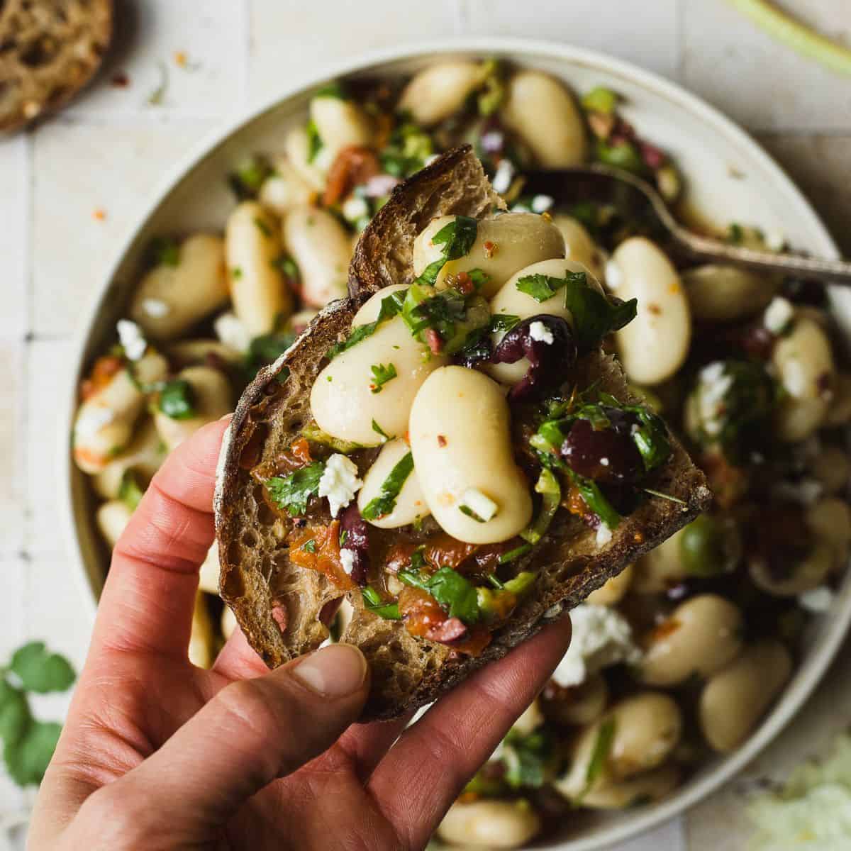 Marinated white beans on a slice of sourdough toast.