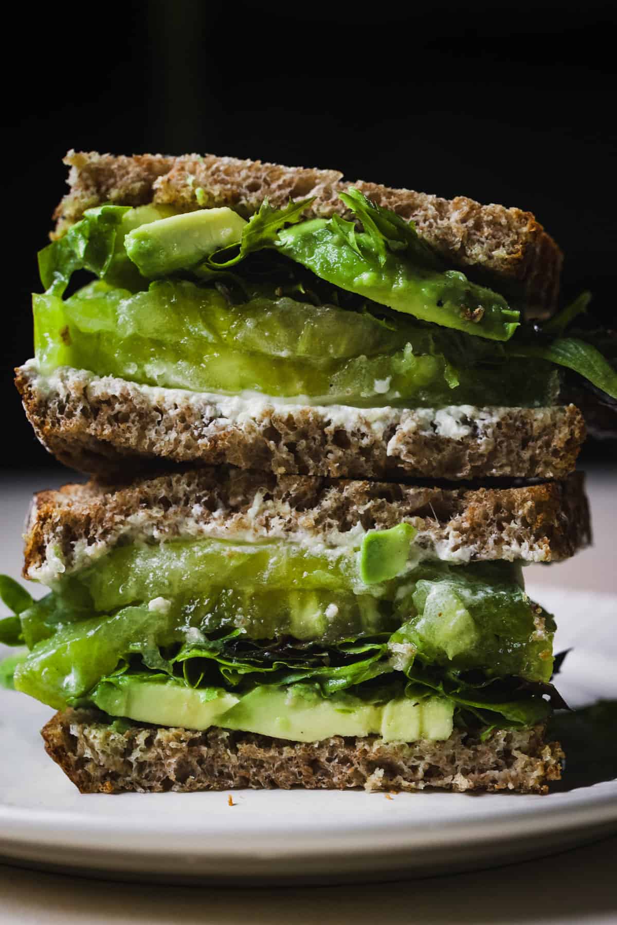 Two tomato sandwich halves, stacked.