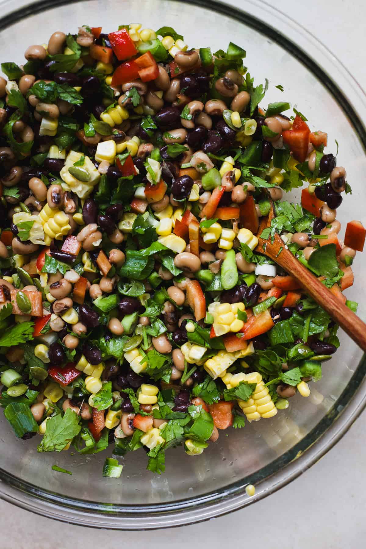 Black bean salad with corn in a large bowl with spoon.