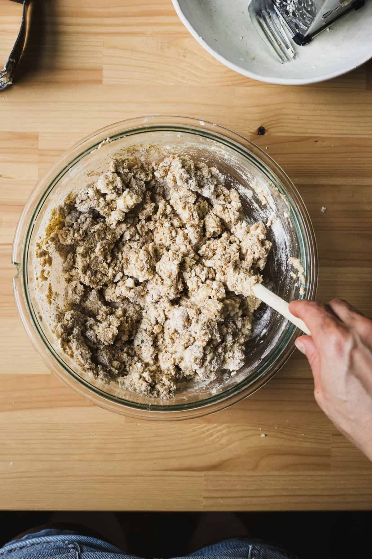Spelt flour scone dough with wet ingredients combined into dry ingredients, in a bowl.