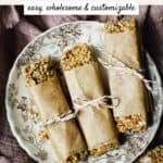 Kitchen sink homemade granola bars on a small plate on a linen, in a wooden tray.