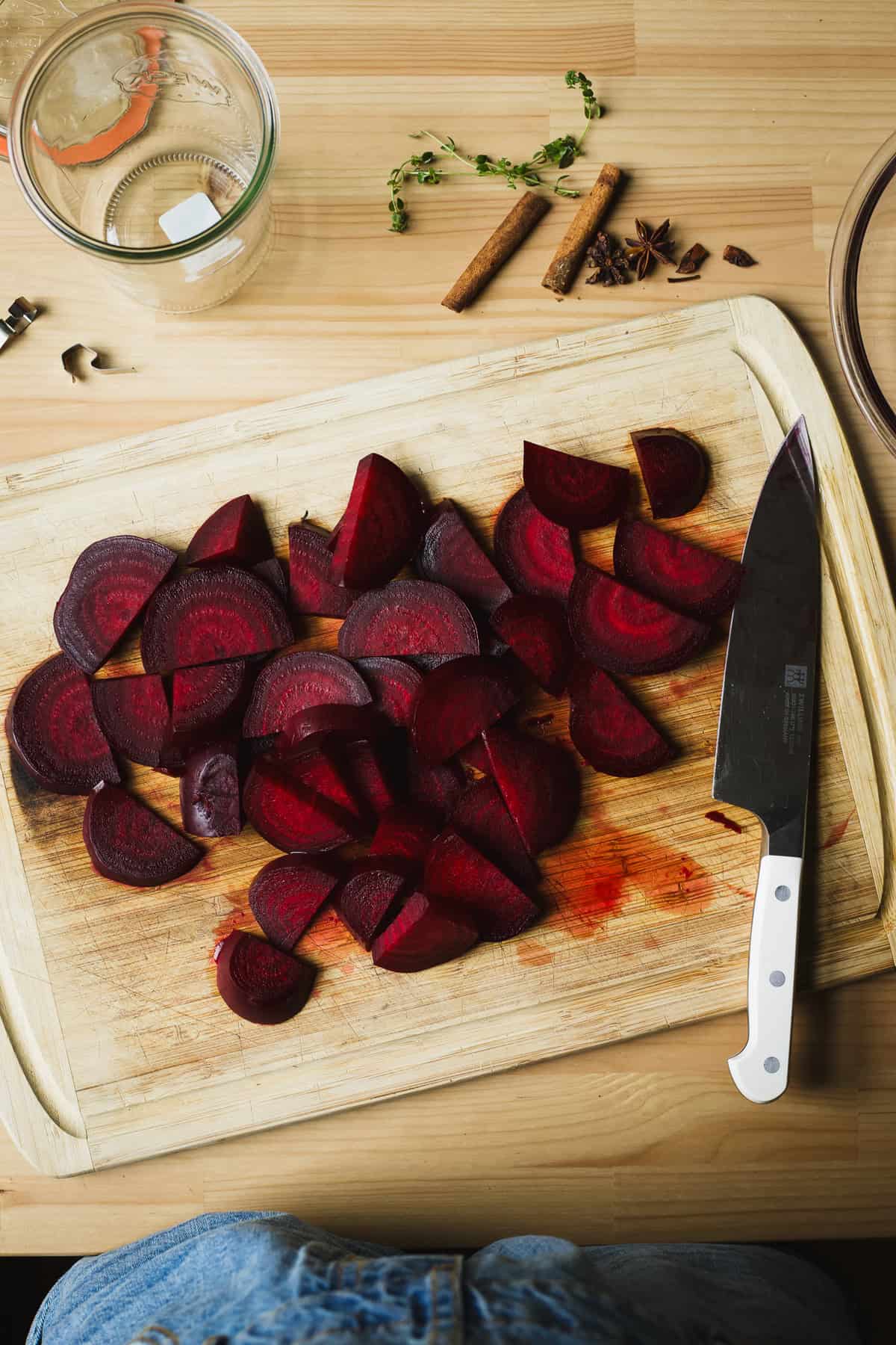 Beet slices on a bamboo cutting board with chef's knife.