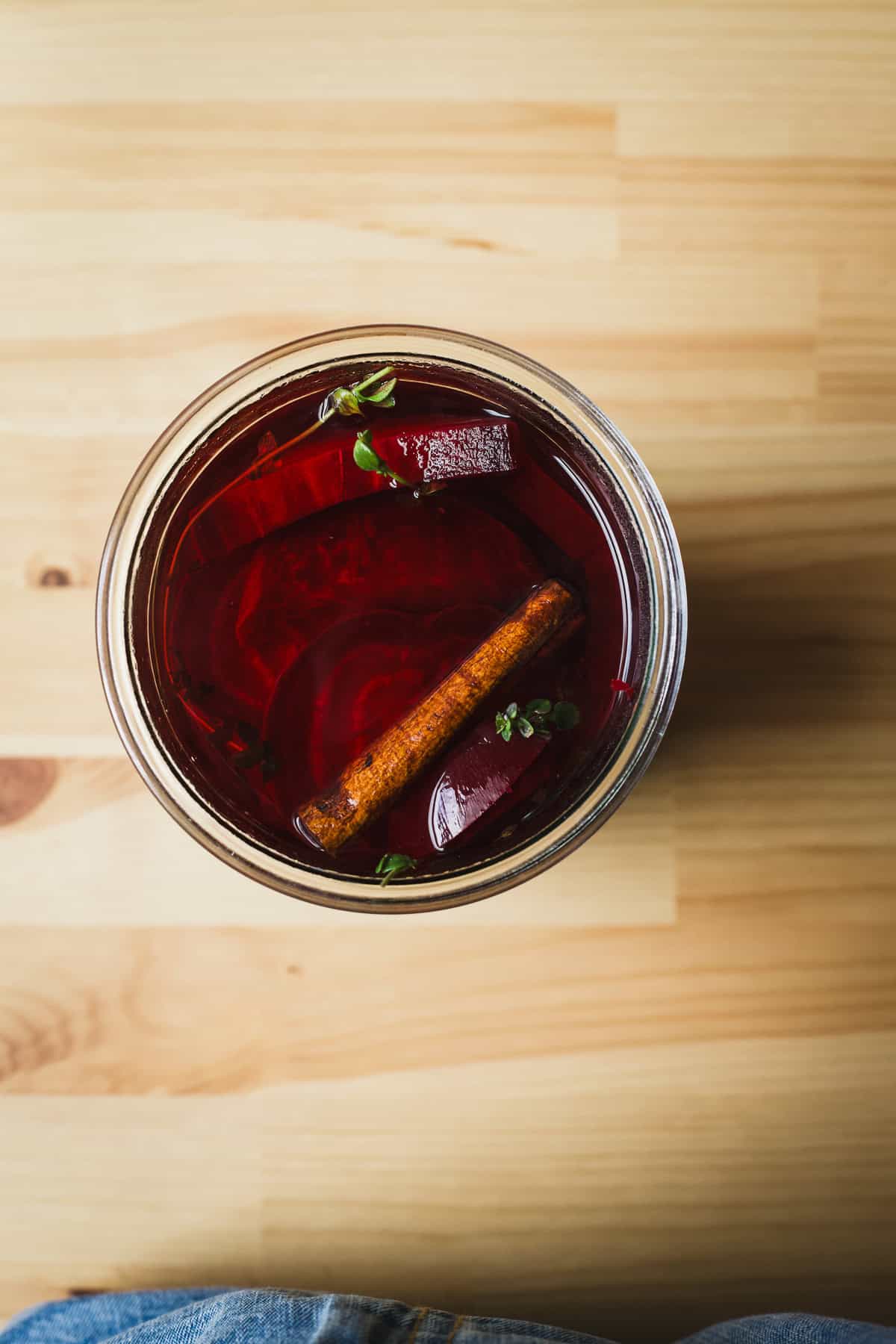 Vinegar and water added to jar of pickled beets ingredients.